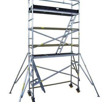 Mobile scaffold tower with wheels and safety rails.